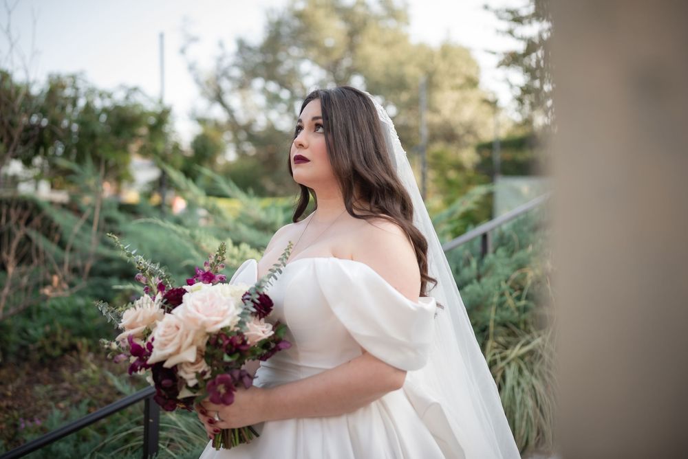 Bride holding bouquet during romantic outdoor garden wedding in Dallas Texas.