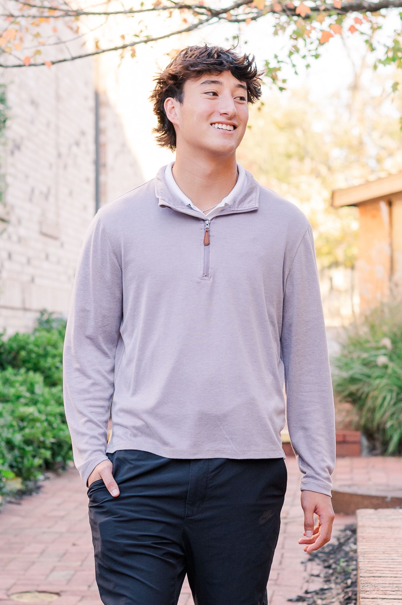 High school senior guy walking in walkway, natural light senior session Senoia GA