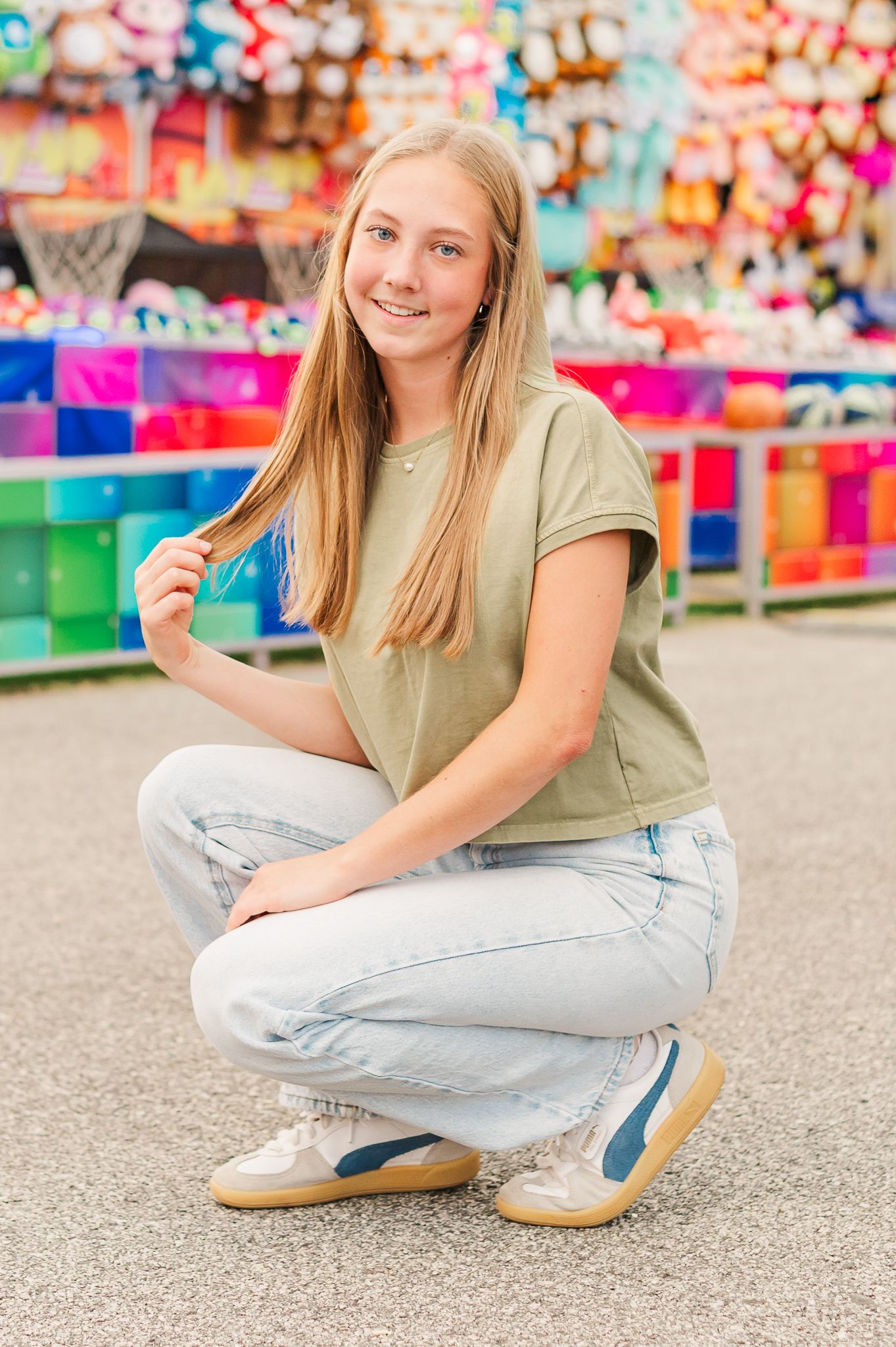 Senior girl posing in front of carnival games at the fair, Newnan, GA