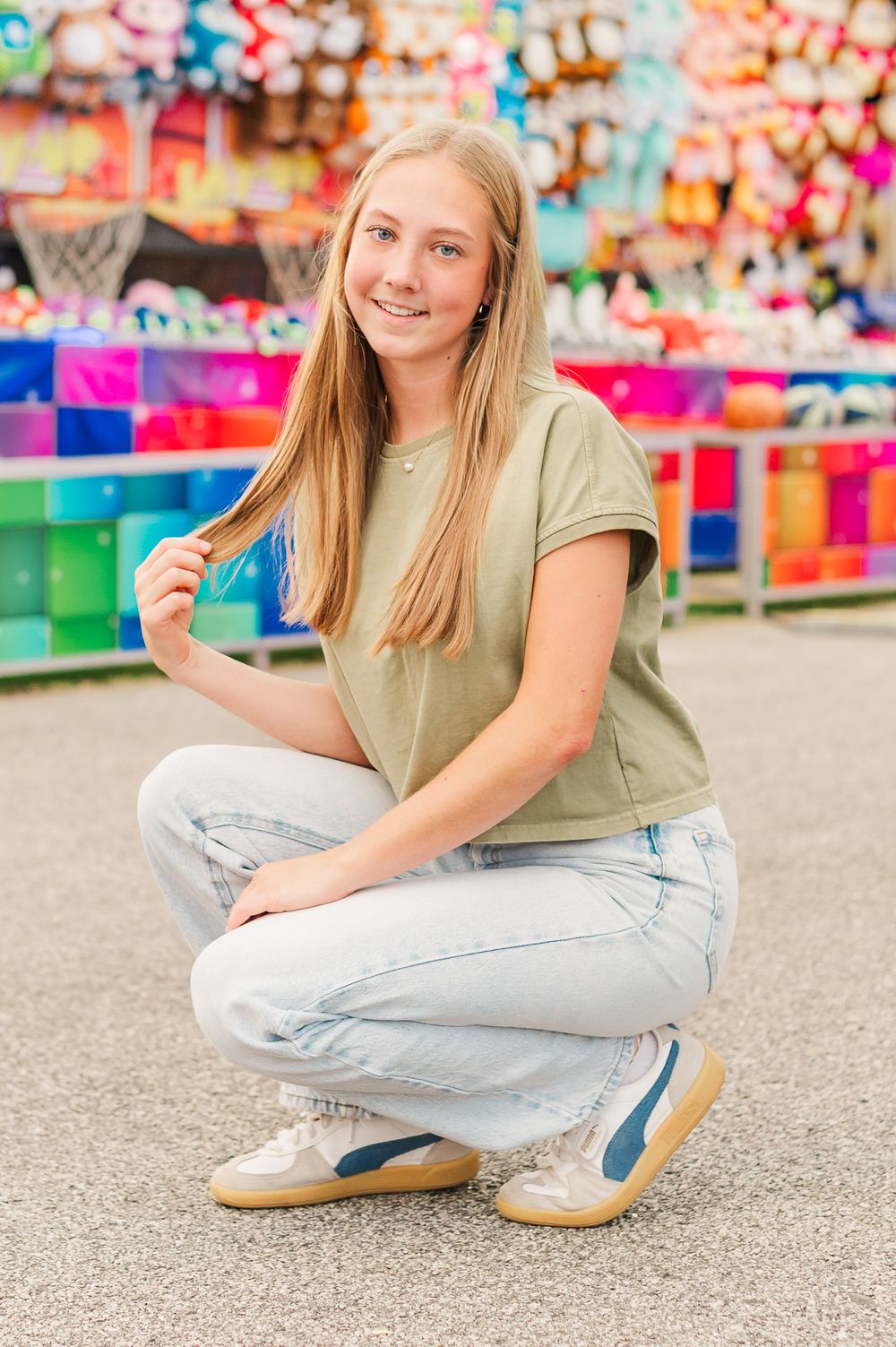 Senior girl posing in front of carnival games at the fair, Newnan, GA