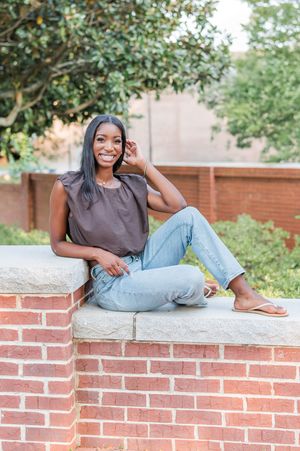 High School senior girl sitting on brick wall, senior portrait Newnan GA