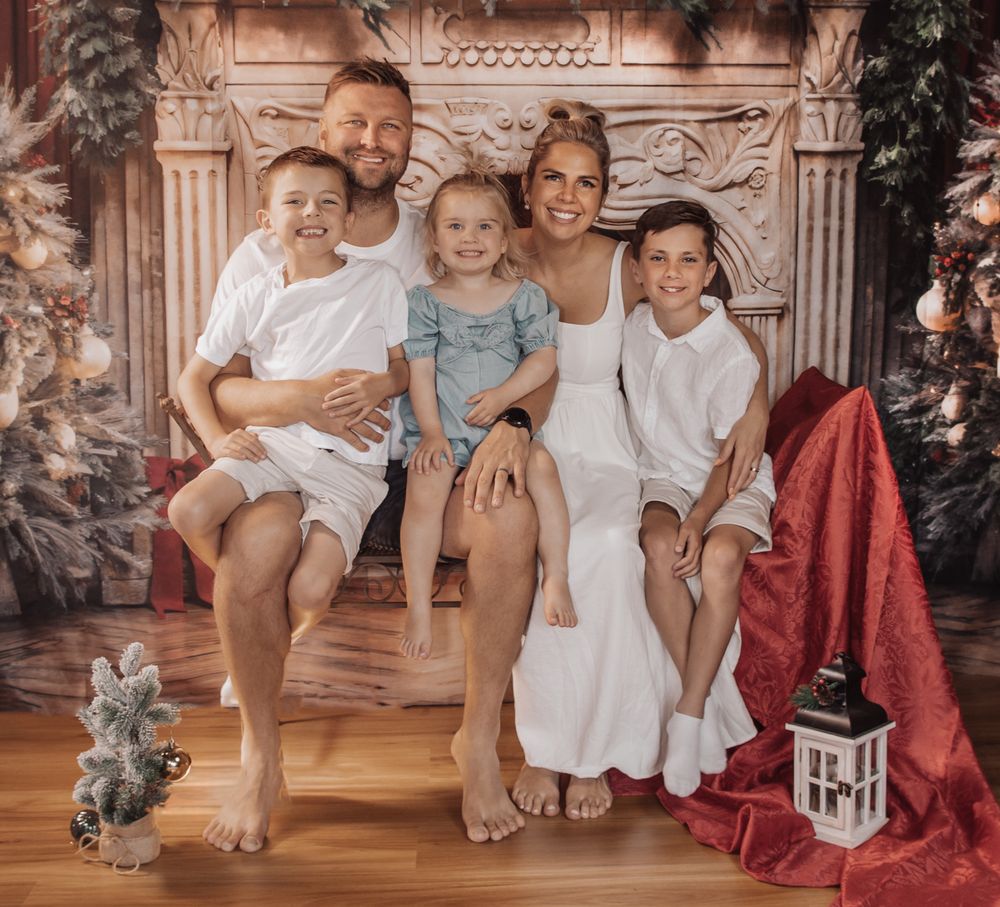 Vintage-style holiday photo collage showing family in white outfits against festive Christmas backdrop with decorations.