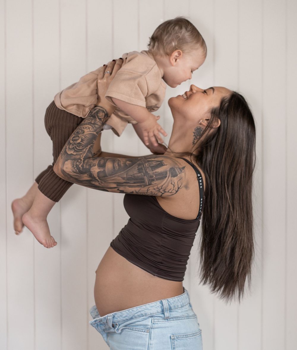 A series of four candid moments between parent and child playing together against a white backdrop.
