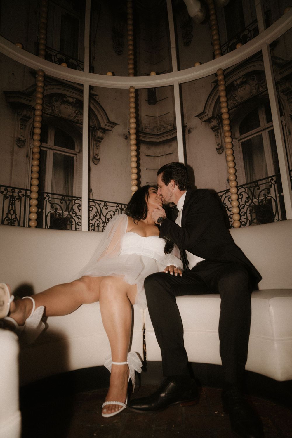A romantic scene in an ornate rotunda with classical architectural details and romantic lighting.