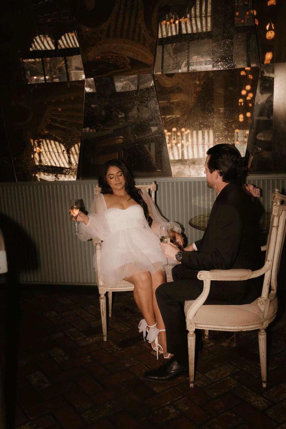 An intimate scene in a darkly lit venue with antique decor and ambient lighting.