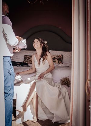 A series of photos showing someone sitting on a bed in a bridal gown during wedding preparations.