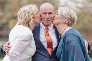 Romantic outdoor wedding portraits showing tender moments between a couple in formal attire.