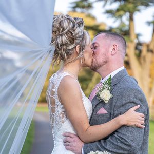 Romantic outdoor wedding photos showing tender moments between newlyweds against natural lighting.