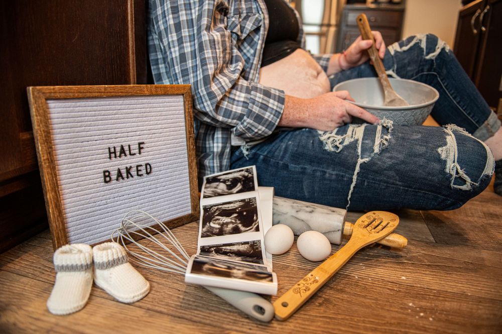 Close-up of hands preparing food on wooden counter with baking tools and ingredients.