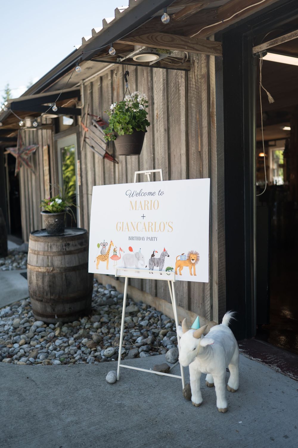 Decorative stuffed animals and party signs displayed near rustic wooden barrels. Nuzzo's Farm Branford Connecticut