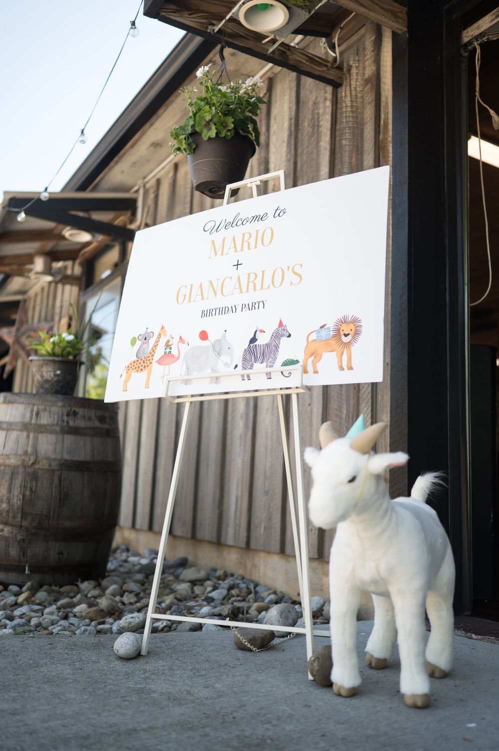 Party welcome signs with animal illustrations displayed alongside stuffed unicorn decorations. Nuzzo's Farm Branford Connecticut