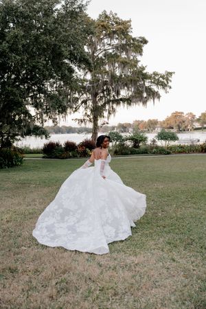 A series of photos showing a white wedding dress flowing gracefully across a grassy lawn beneath Spanish moss-draped trees.