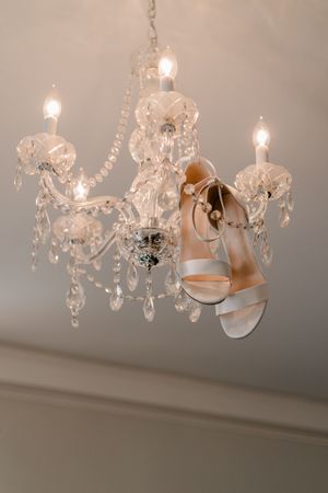 A sequence of images showing elegant crystal chandelier lighting with soft illumination against a white ceiling.