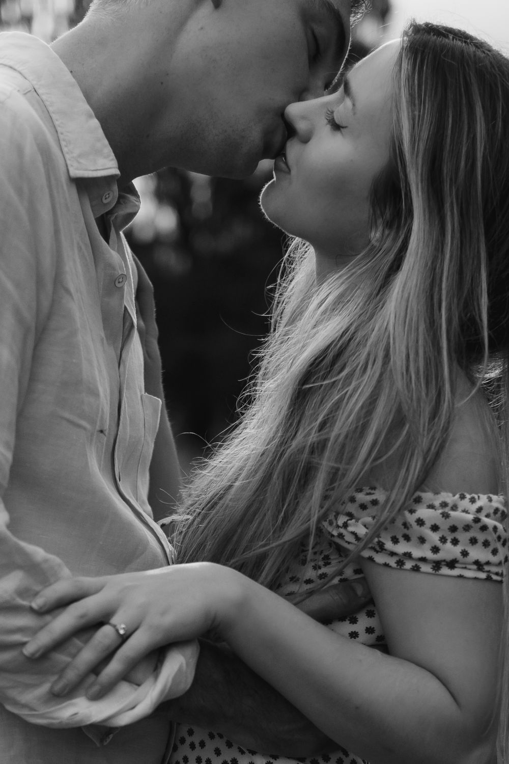 Two people share an intimate black and white moment in a romantic sequence of images.