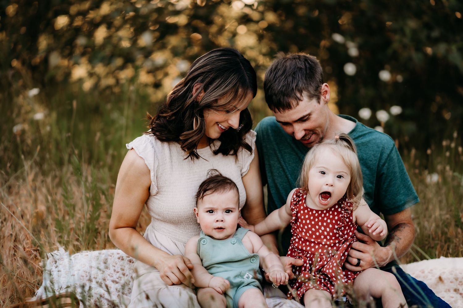 Ben and Chelsea share a cuddly embrace during their outdoor maternity session while their son wraps them up in a leash