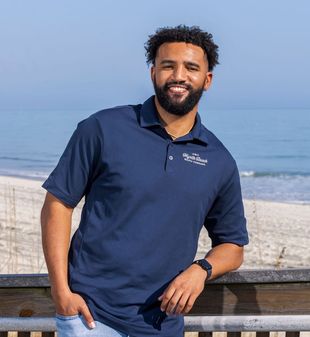 Professional headshot of a man on the beach in Myrtle Beach boardwalk.