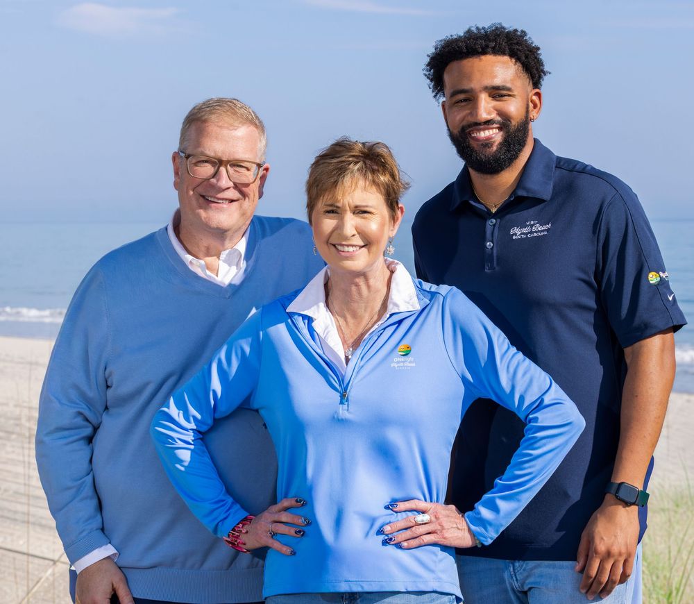 Team portrait of three professionals on the beach in Myrtle Beach boardwalk.