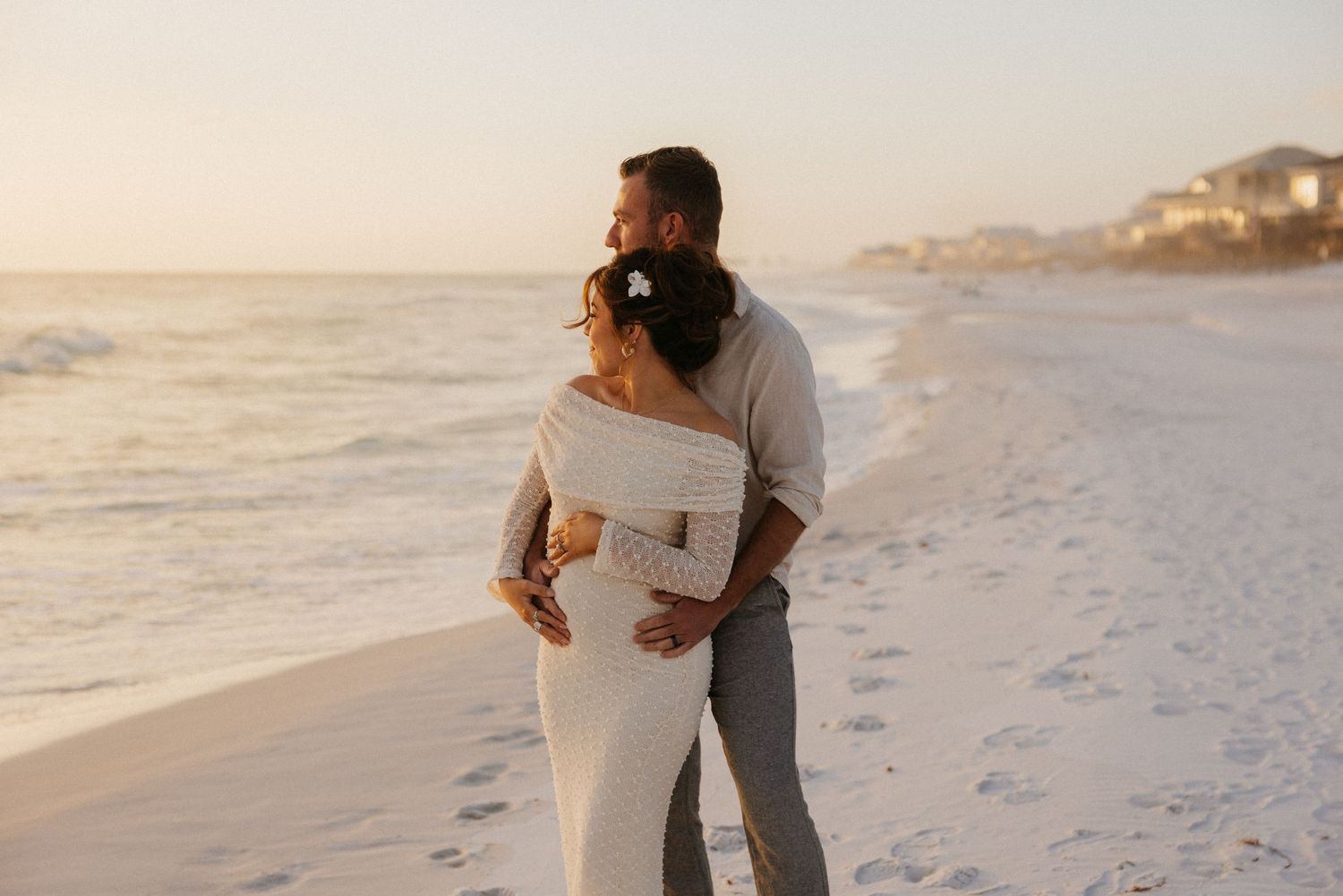 a couple taking maternity photos on the beaches on 30A in Santa Rosa Beach, FL