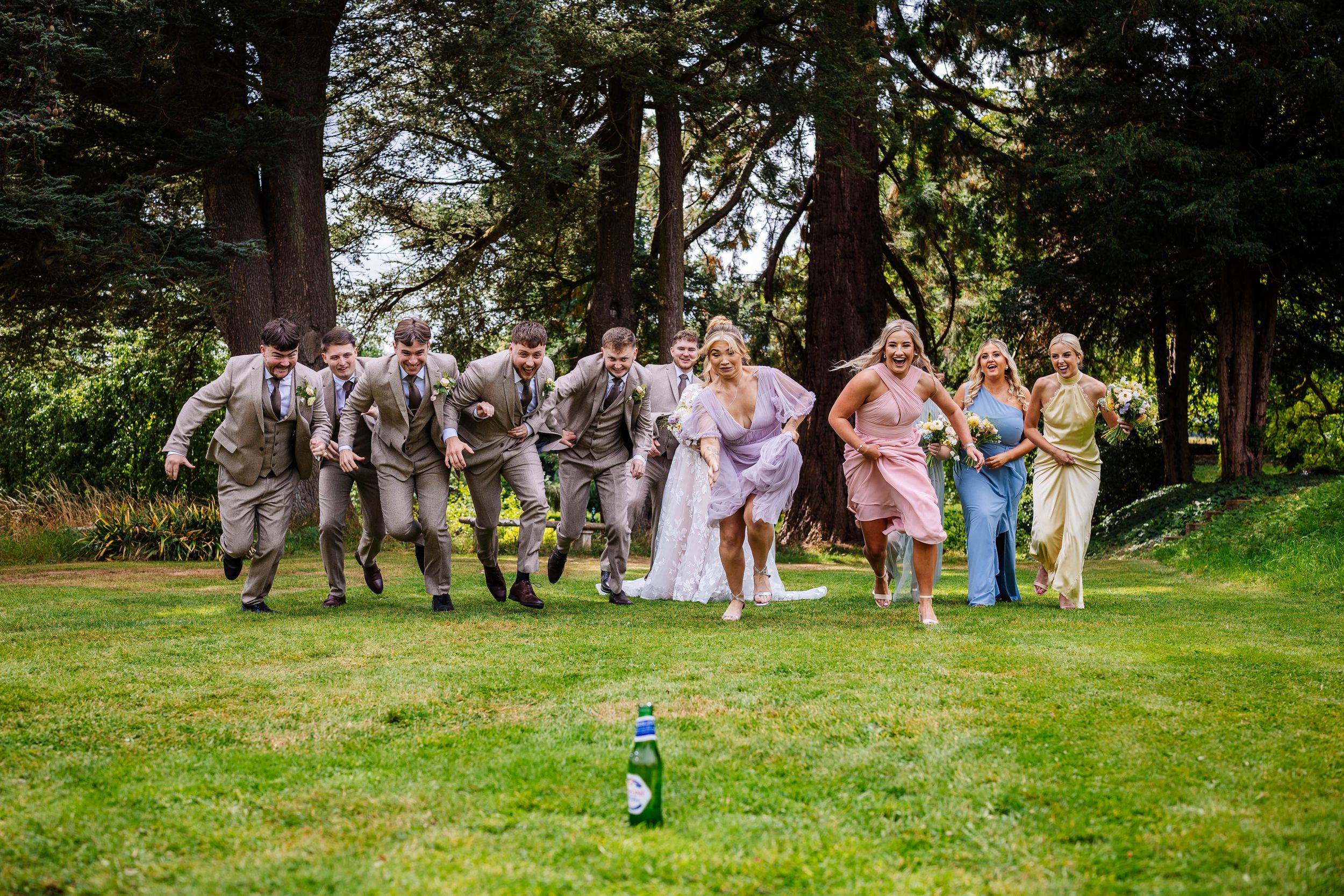 Chase the beer, wedding party fun at askham hall, captured by Lynette Matthews Photography, lake district wedding photographer