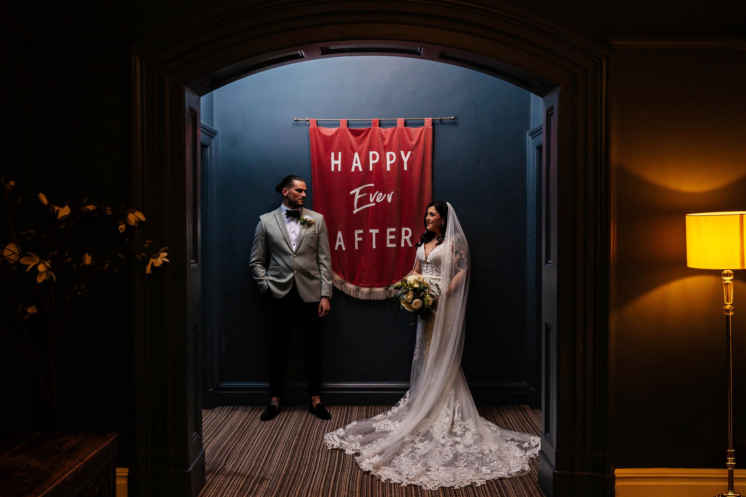 An evening shot of a tattooed bride and groom during a relaxed pose at their Ashfield House wedding, Wigan captured by Lynette Matthews