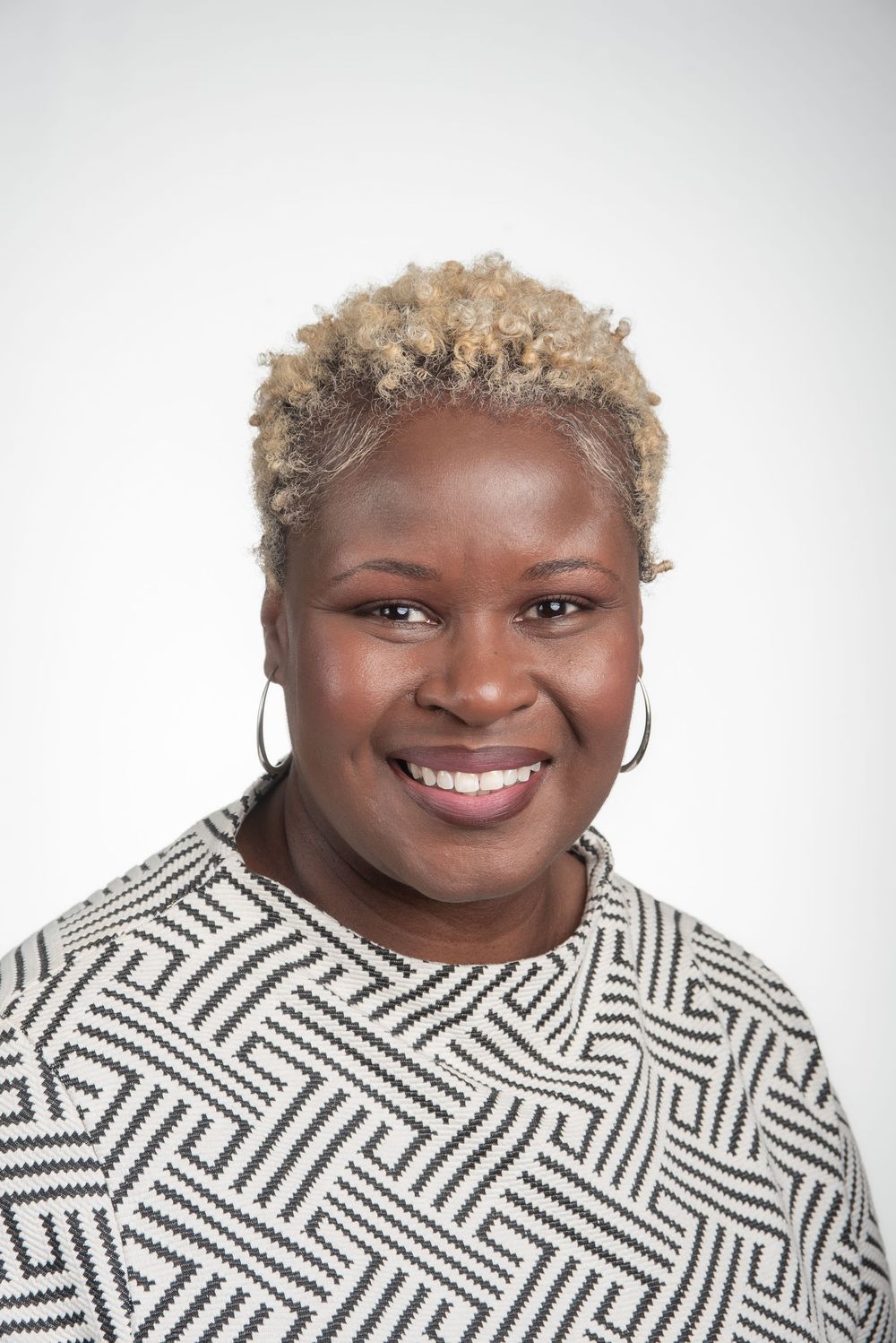 Professional Headshot of black Memphis woman with blonde hair and white background.