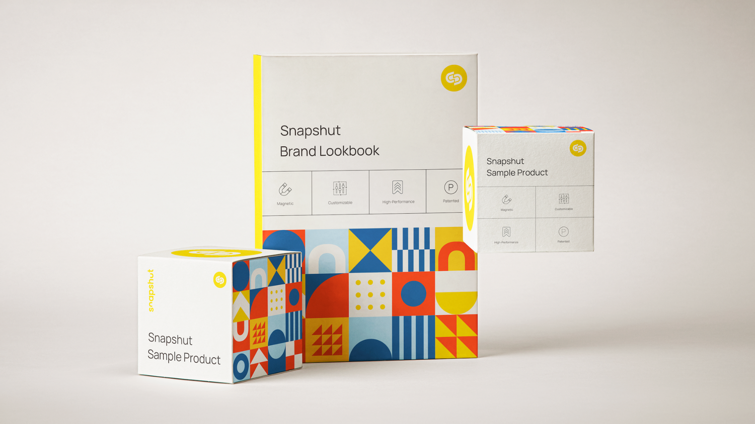 Colorful geometric patterned product boxes with yellow accents and brand lookbook materials.