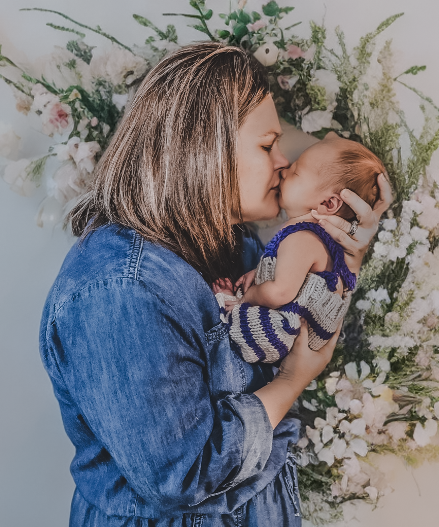 Mother in denim jacket holding baby against floral background in series of tender moments.