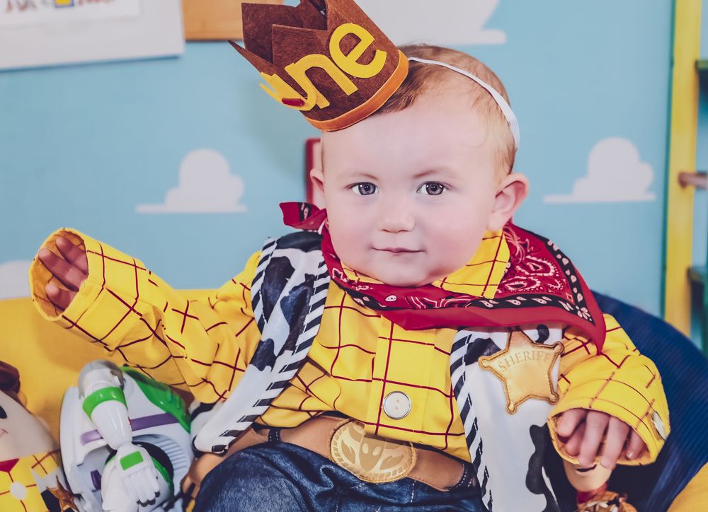 Toy Story themed birthday party decorations with colorful balloons and characters.