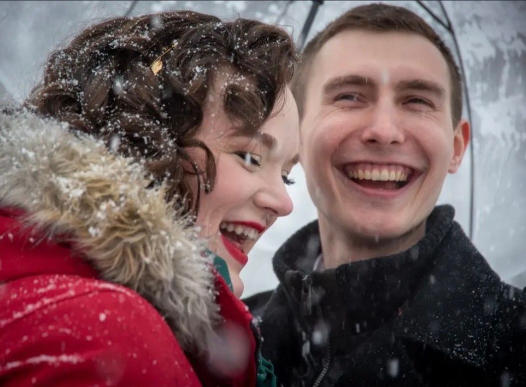 Happy winter wedding portrait in a snowstorm in Upstate NY.