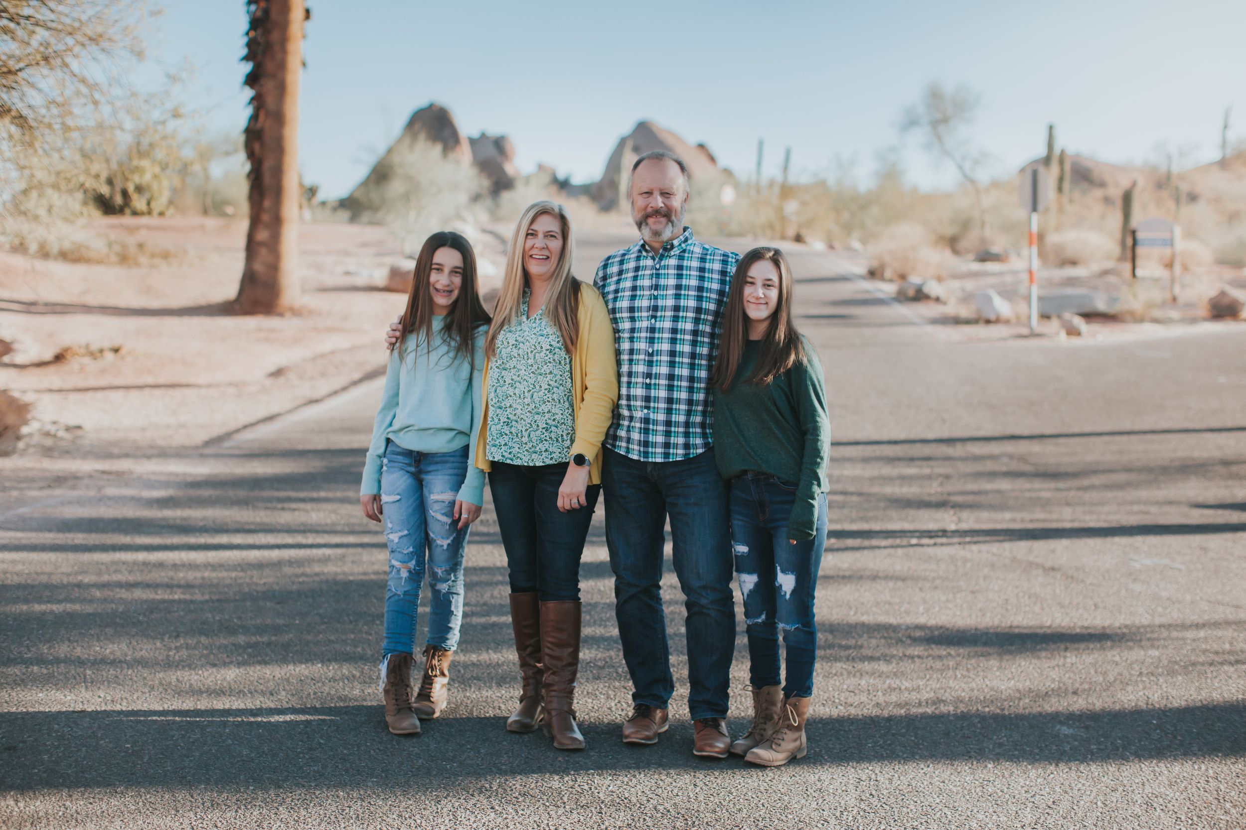 Desert landscape family photography session with mountains and cacti at golden hour.