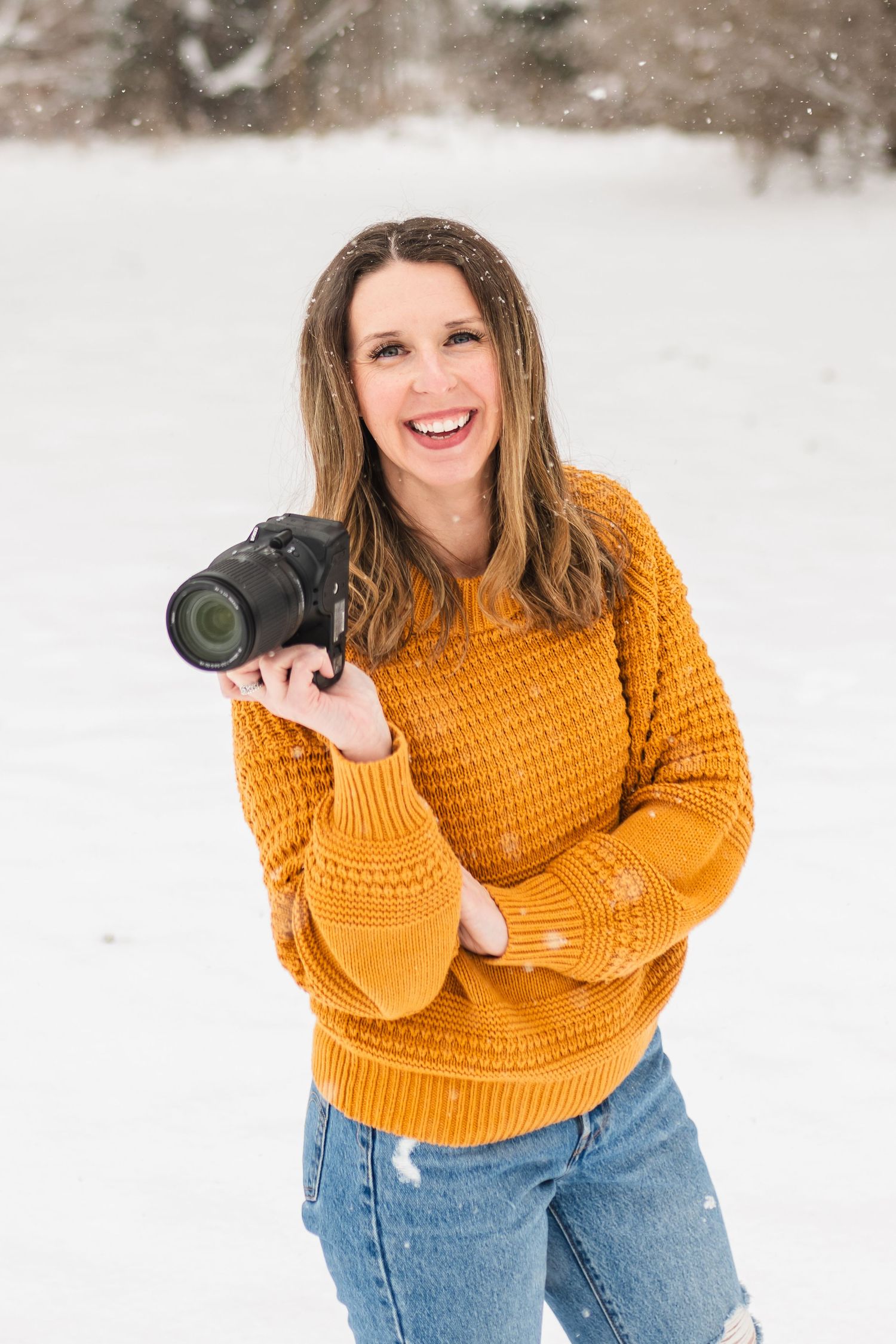 Winter portrait of photographer Kayla Green, posing in the snow in Portland Michigan.