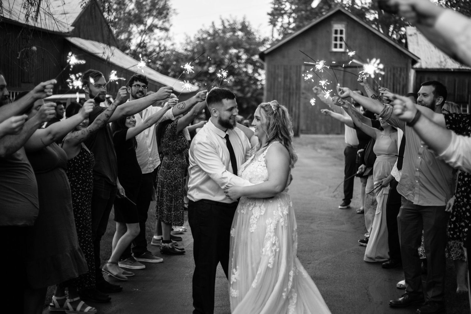 Bride and groom in sparkler tunnel