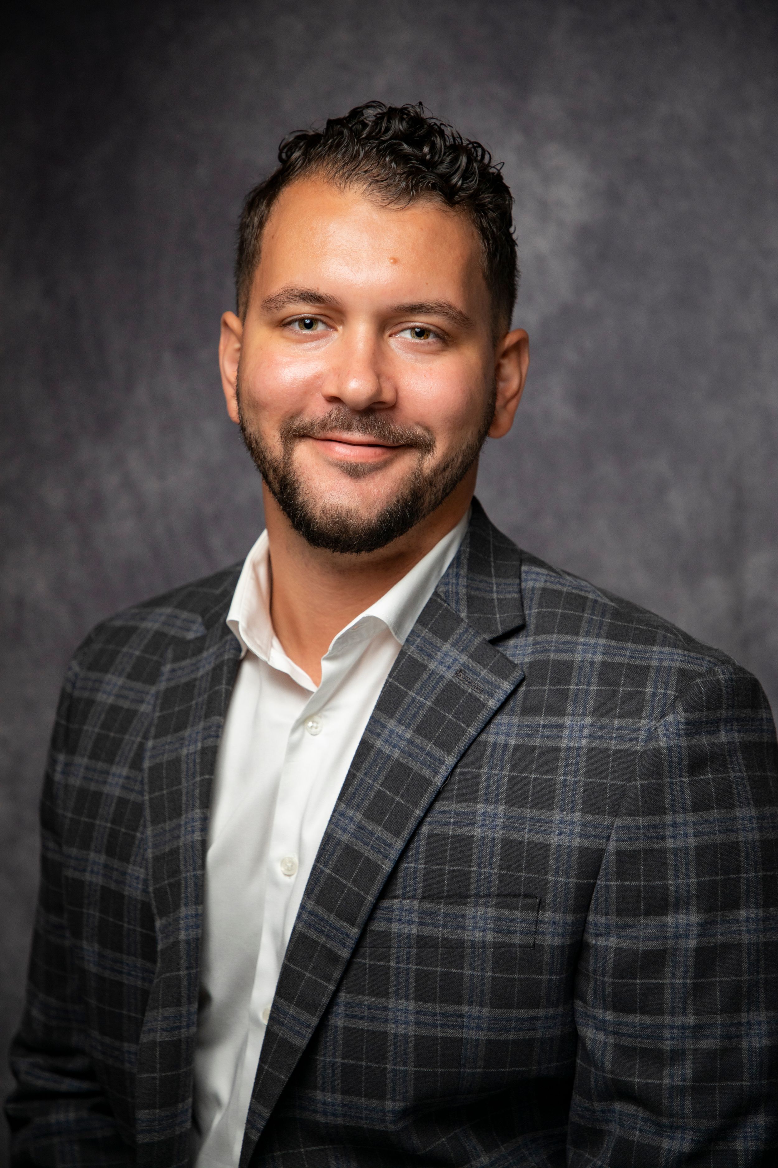Business portrait sequence showing person in plaid blazer and white shirt.