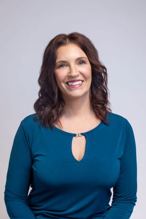 Professional headshots of woman in teal top against grey background showing different expressions.