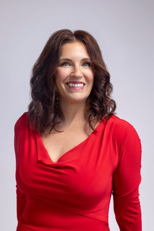 Portrait series of woman in red dress showing warm expressions against grey background.