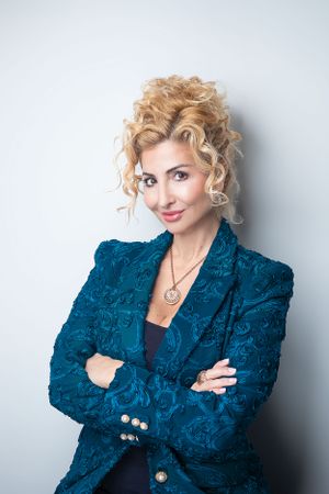 Professional portrait series showing different poses in a textured blue blazer against a light background.