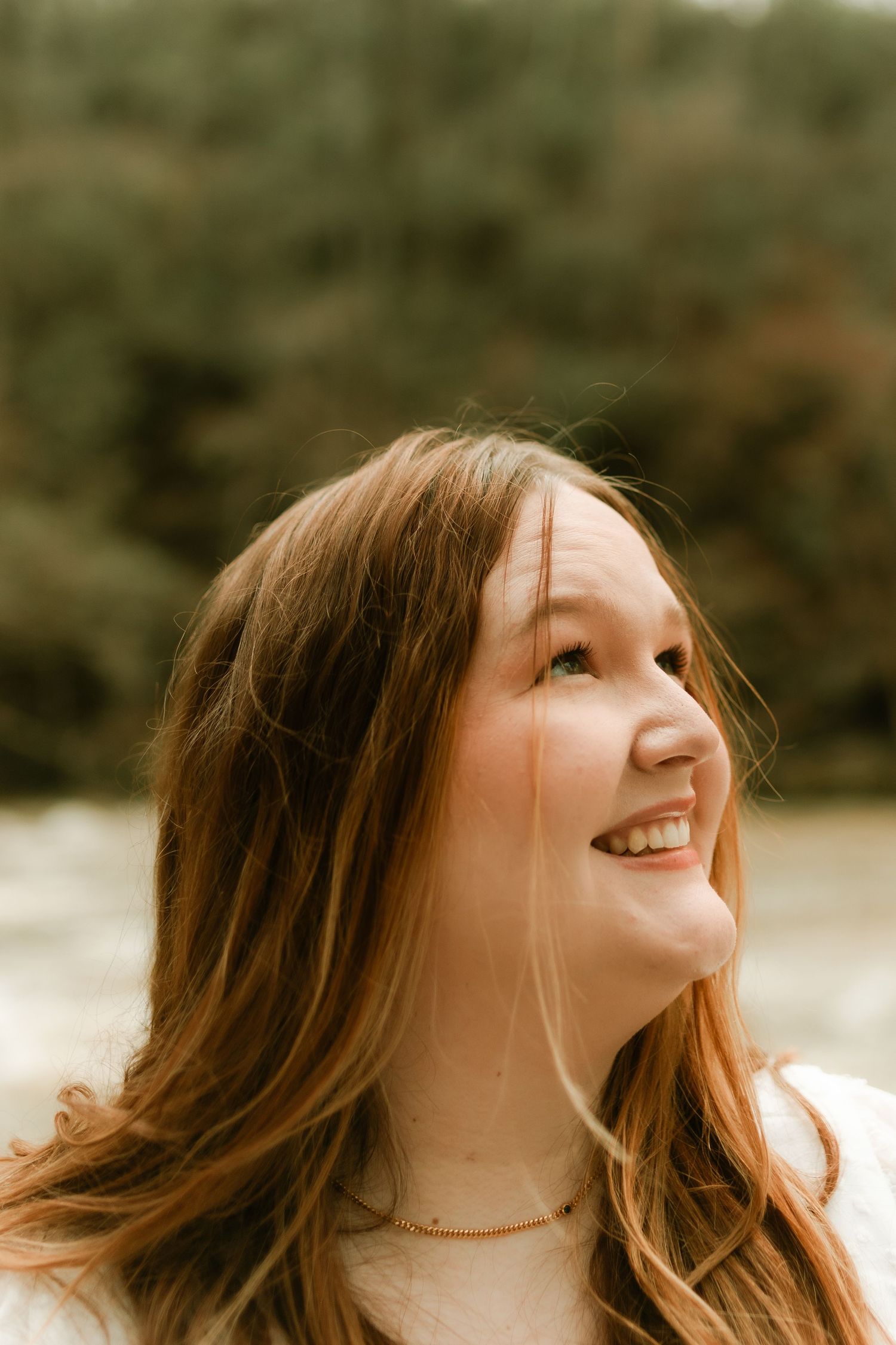 Candid portrait sequence showing joyful expression against natural outdoor setting.