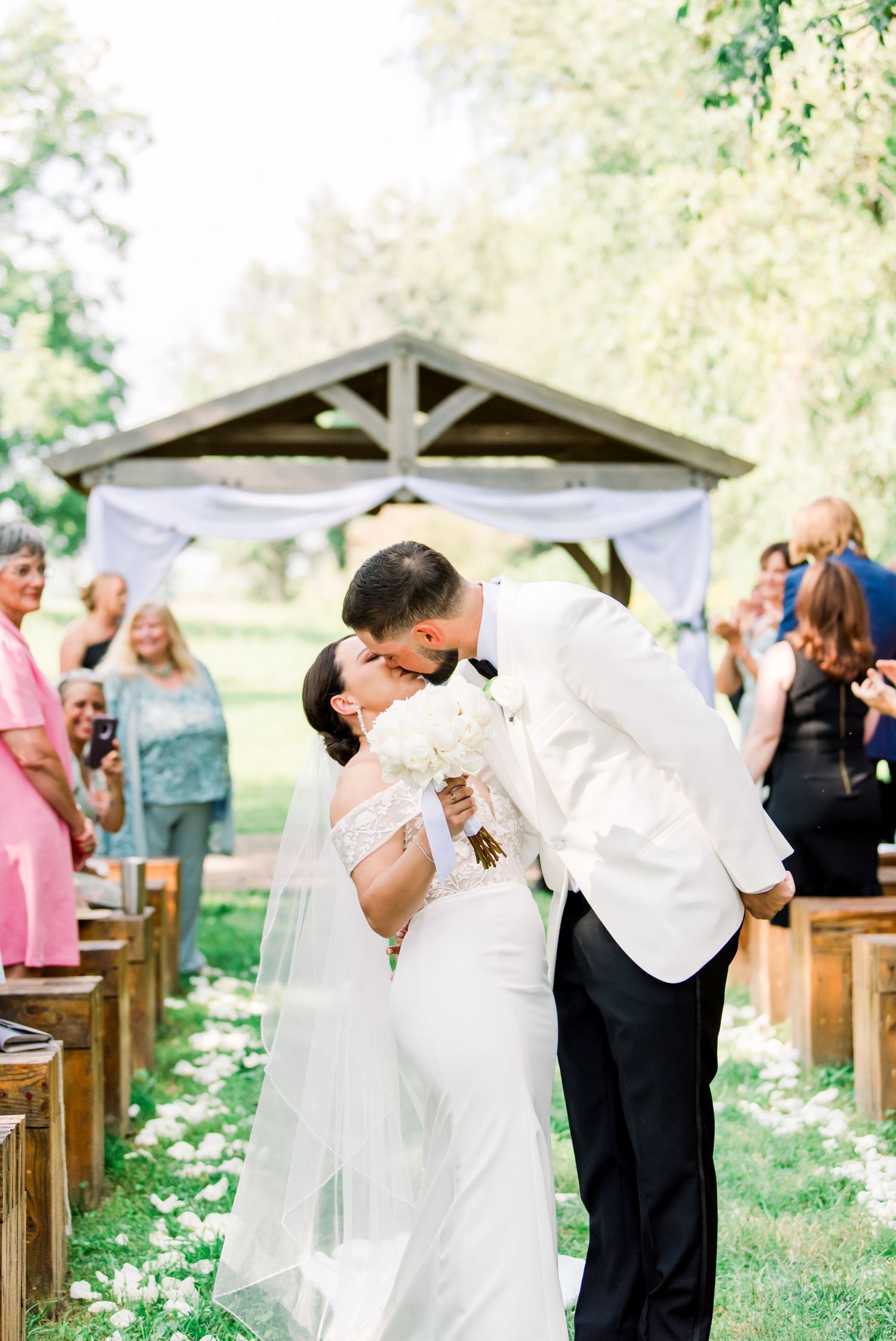 Wedding couple sharing an intimate moment under a white garden gazebo. Indianapolis, Indiana. Angela Hartwig Photography.