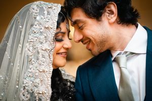 Romantic couple shares tender moments in five sequential wedding photos against an elegant backdrop with white floral decor.