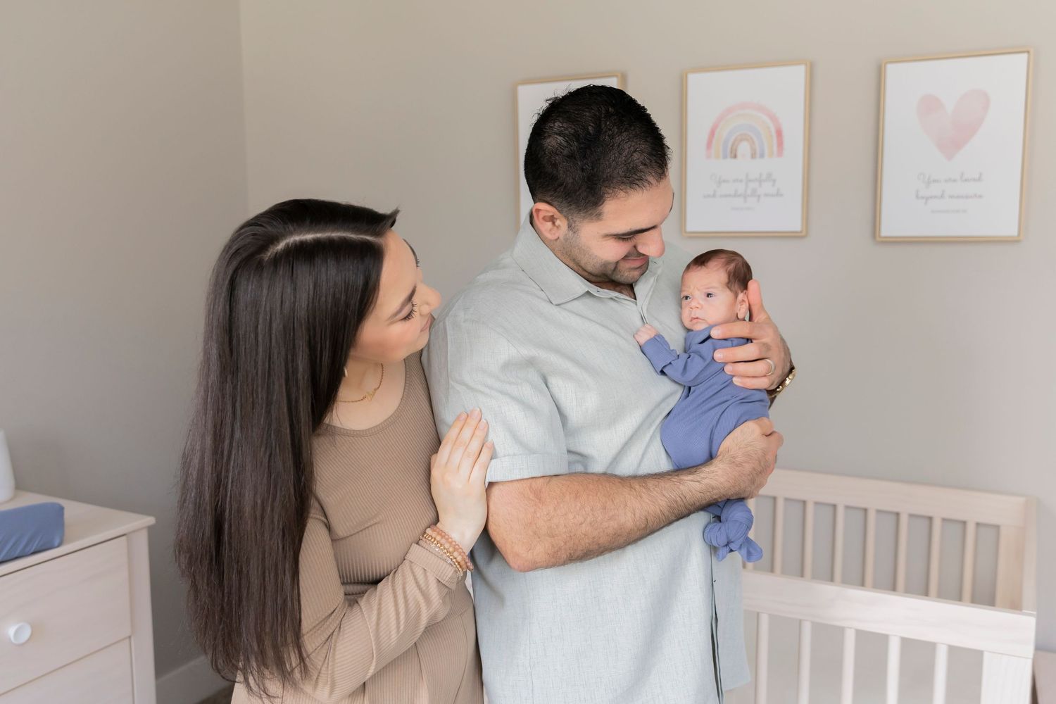 family holding their newborn baby boy in his nursery in their Rochester Hills Oakland County home