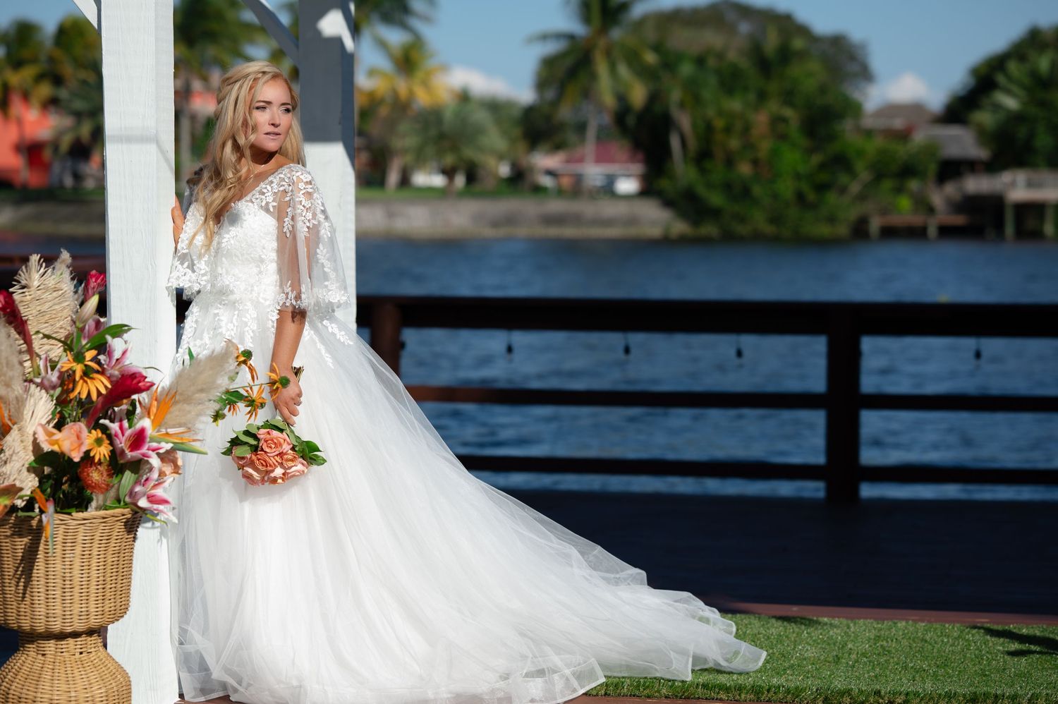 Bride and groom on waterfront terrace in West Palm Beach, captured by editorial-style South Florida wedding photographers.