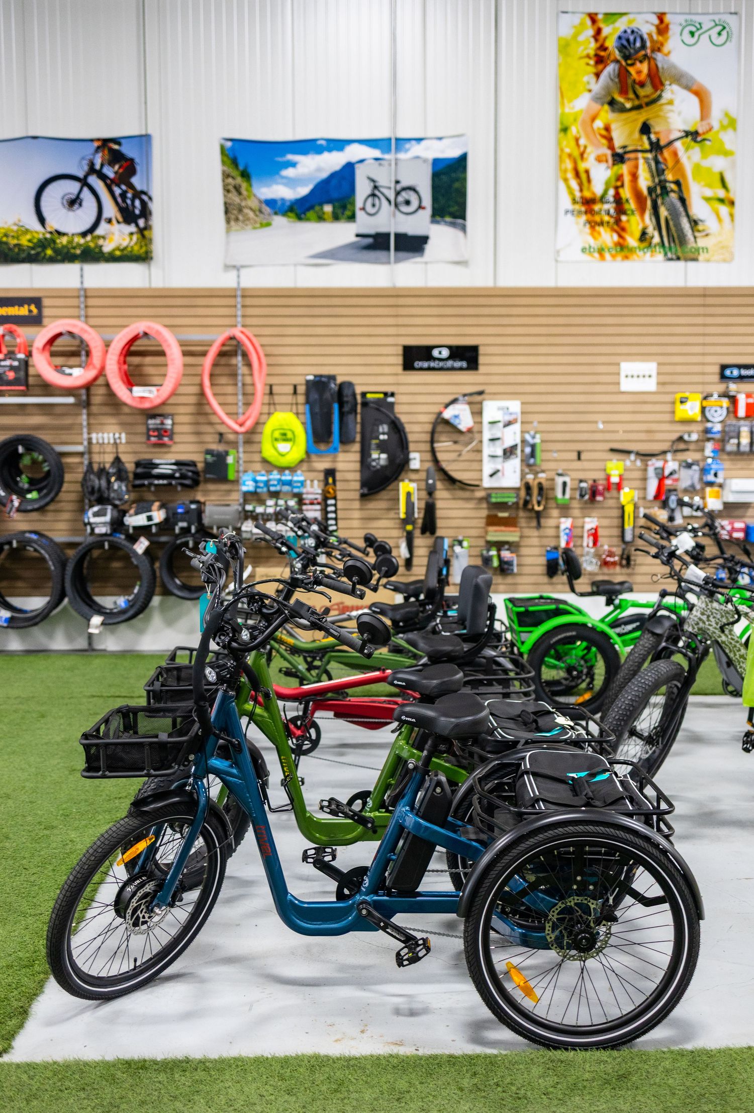 Electric bikes on display in a retail showroom with colorful wall decorations.