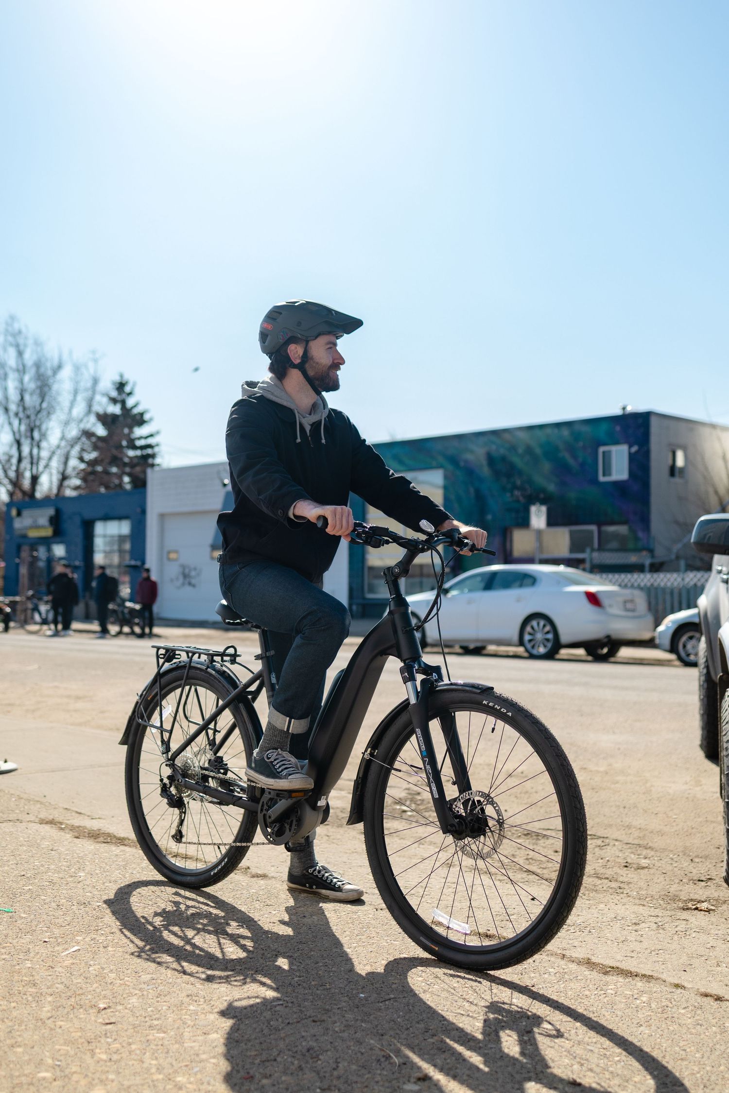 Electric bike being tested in a parking lot on a sunny day.