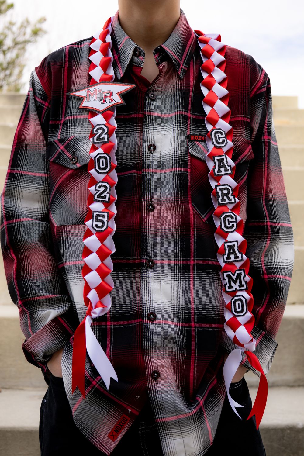 Red and black plaid button-up shirt with decorative graduation sash displaying class year and school colors.