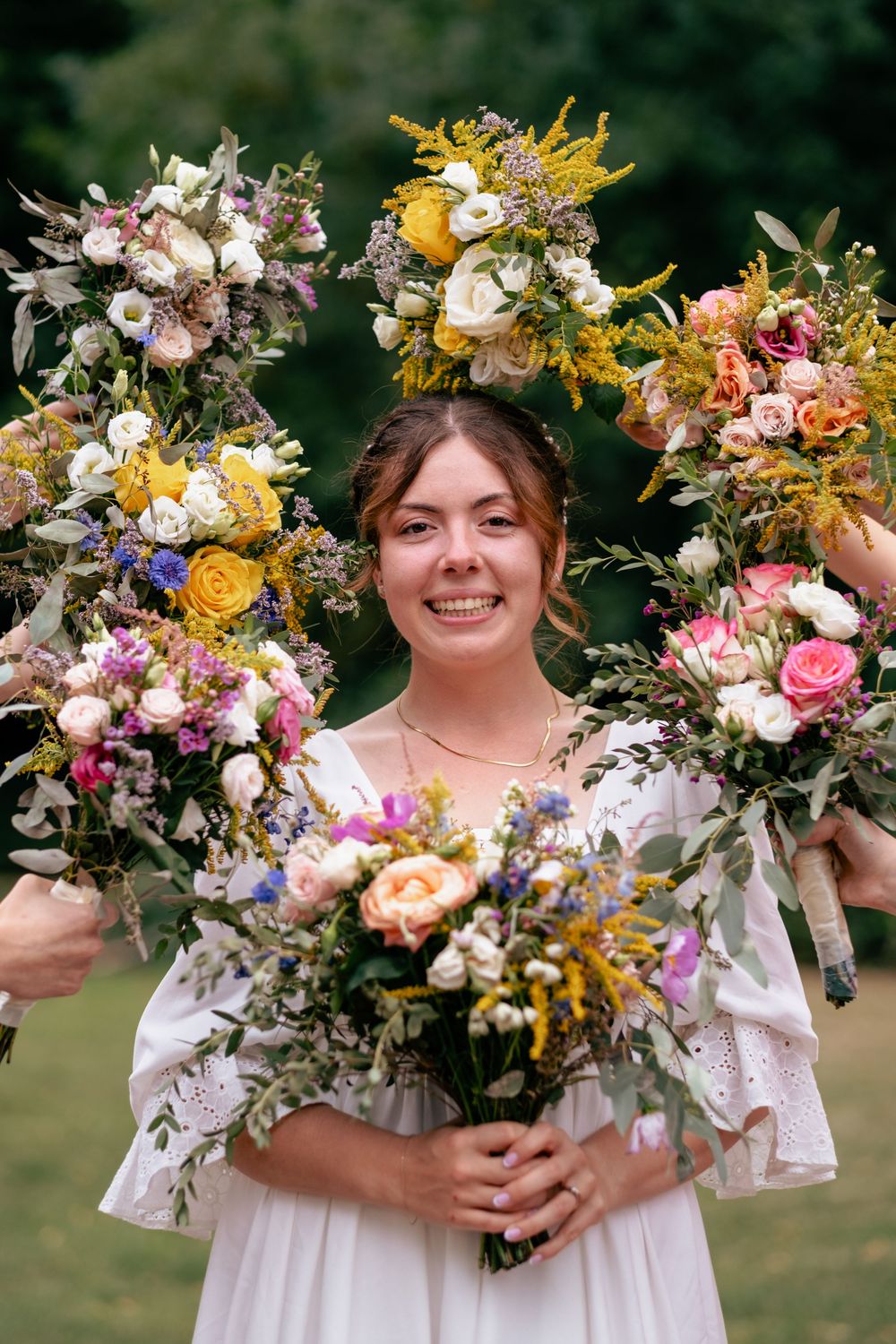 A series of floral bouquets featuring colorful wildflowers, roses, and greenery arranged in a rustic garden style.