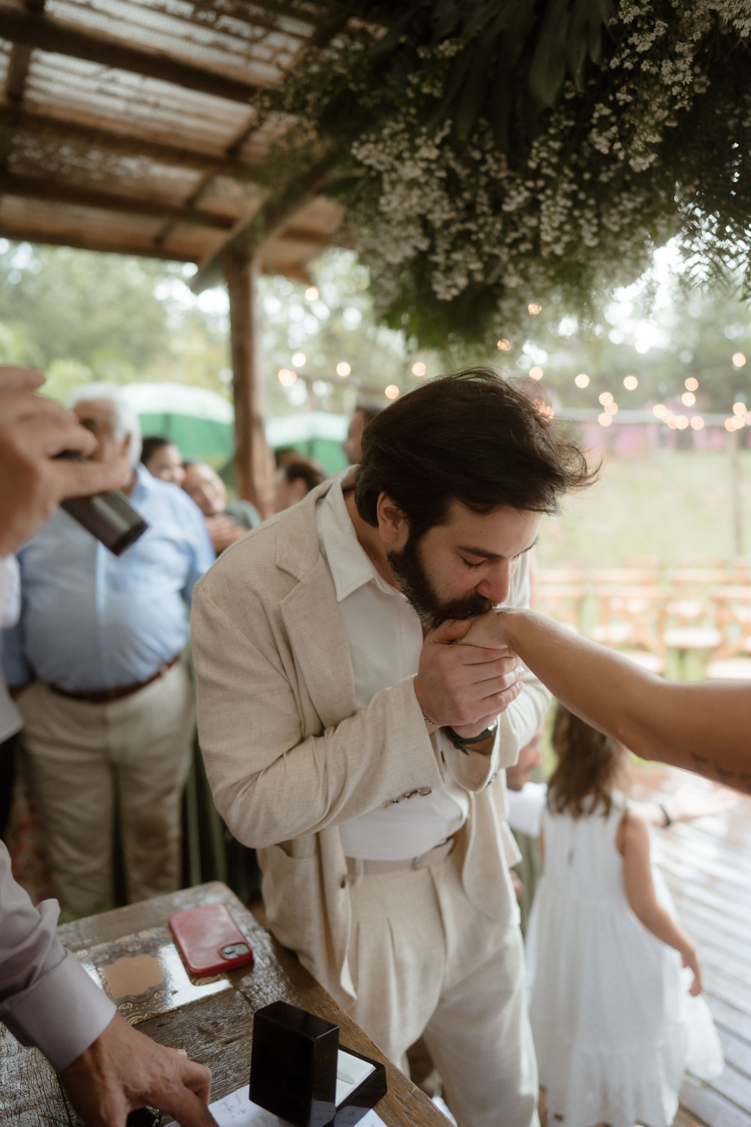 Wedding celebration sequence showing dancing and emotional moments under a covered outdoor venue.