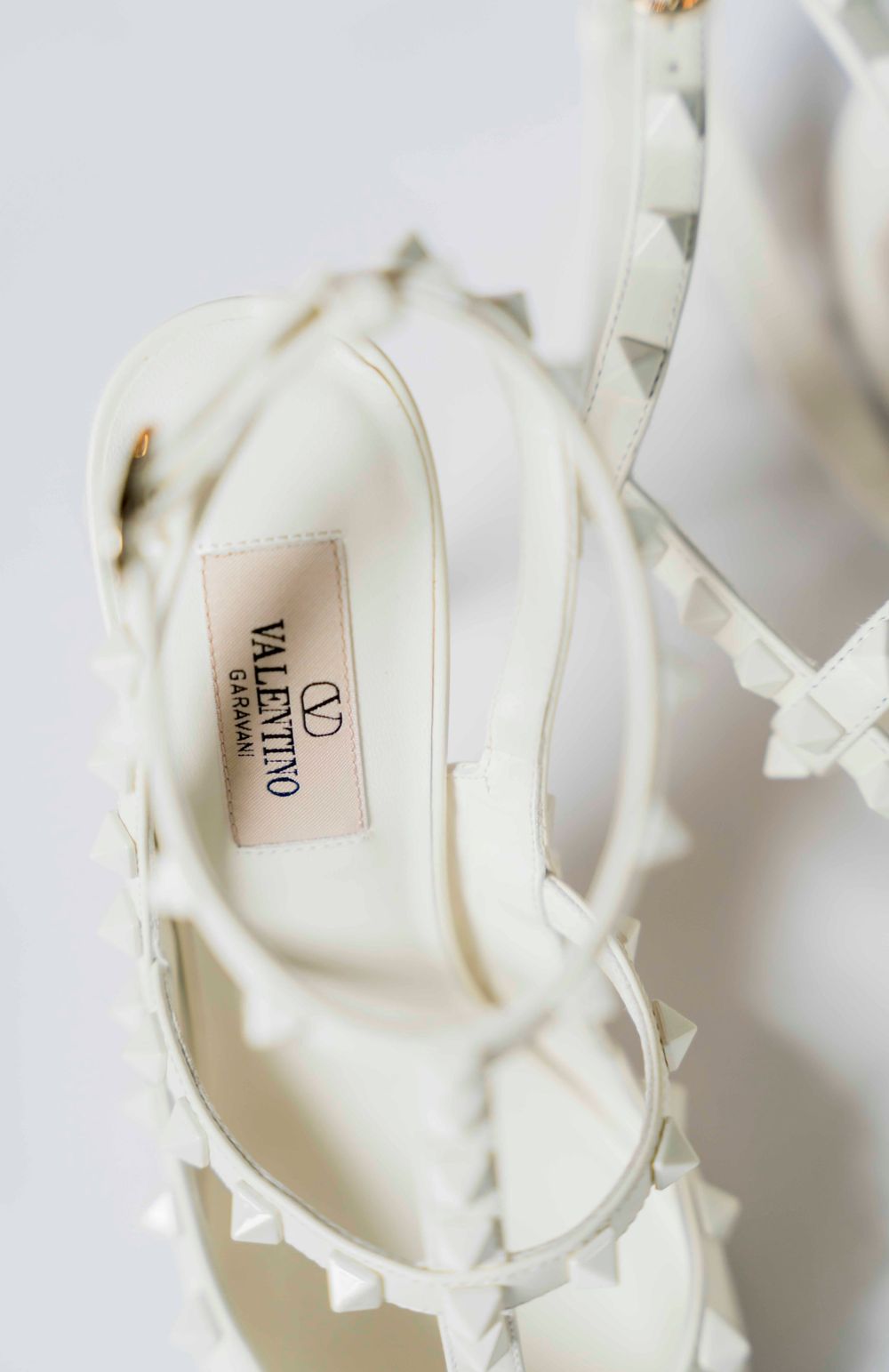 A white Valentino designer bridal shoe with delicate bow details.