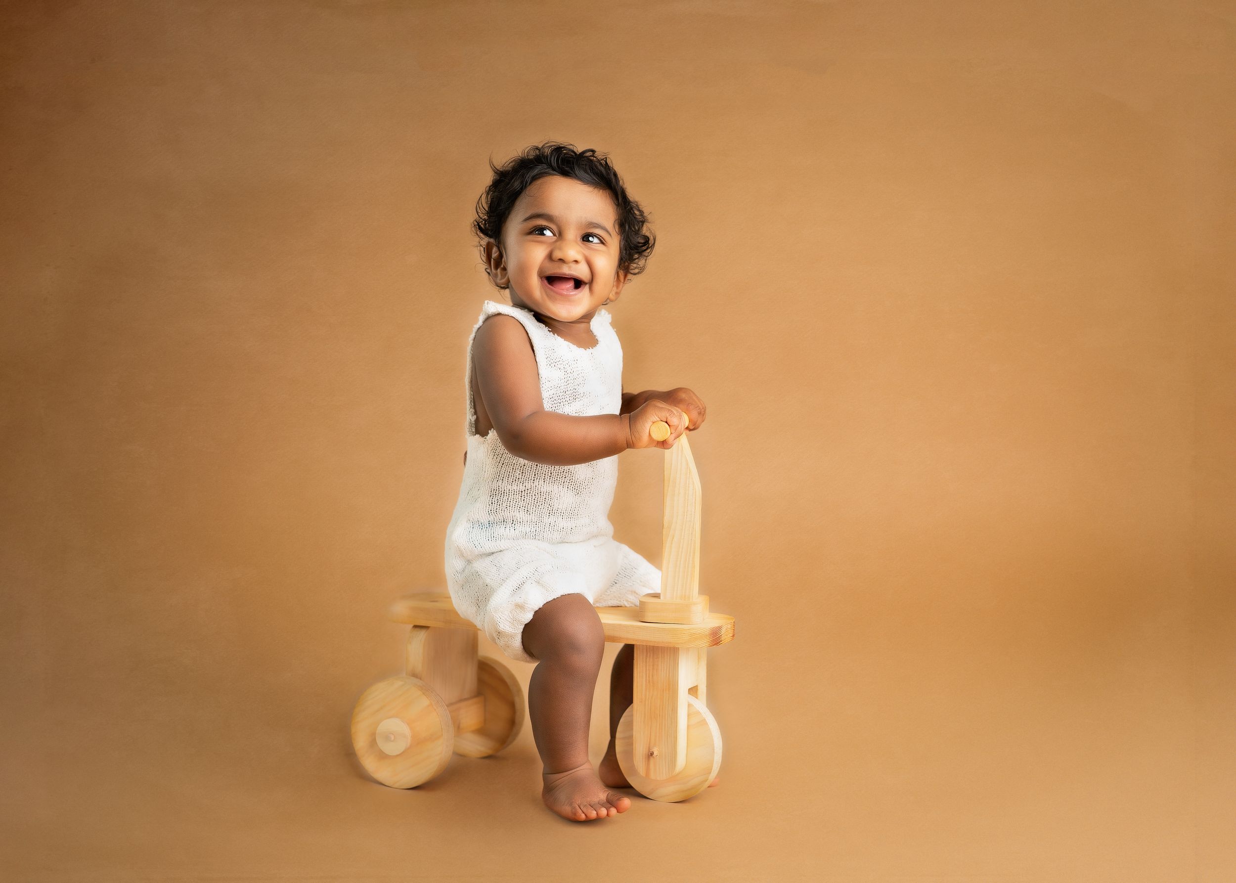 a young boy smiles in a studio with a minneapolis photographer