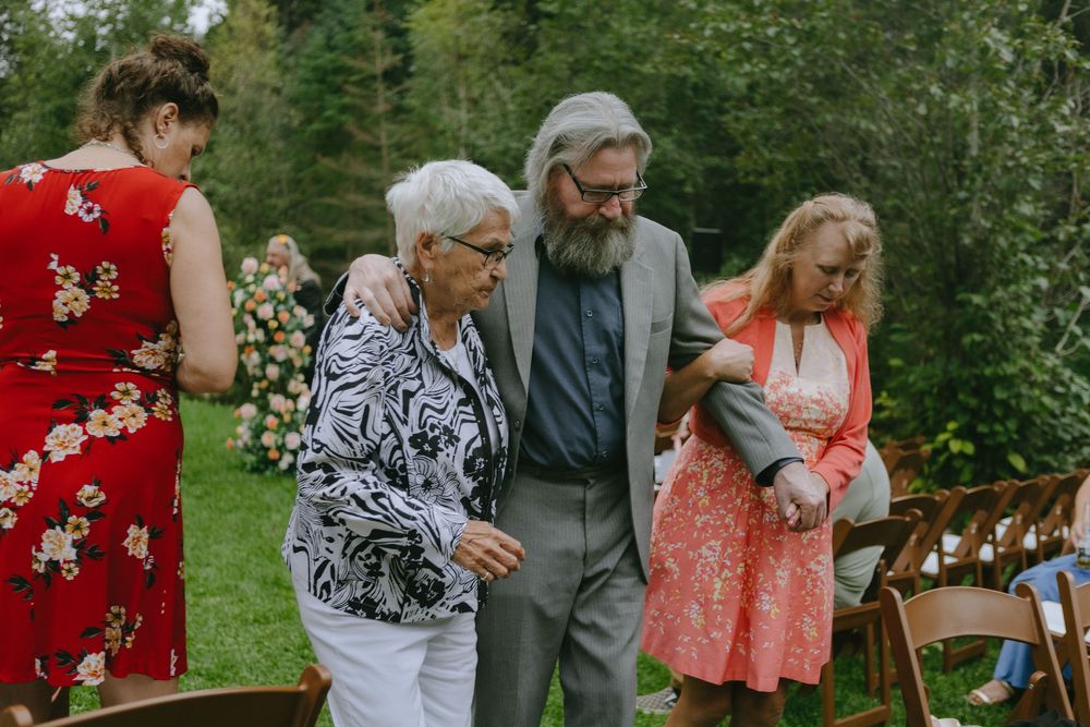 A group of guests enjoying an outdoor garden celebration with casual attire.