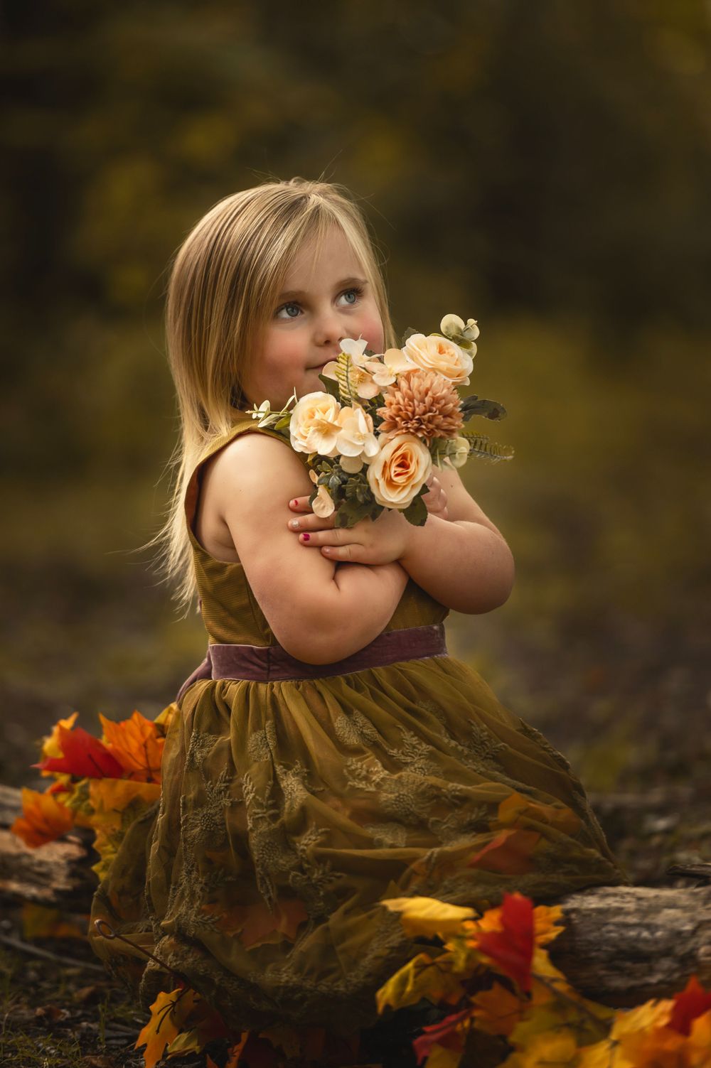 Autumn portrait with peach roses and fall leaves against a warm brown background.